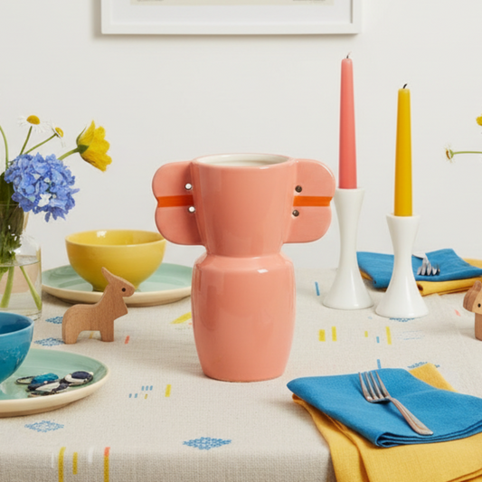 Pink vase with orange accents on a white background