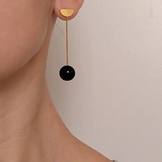 MISMATCHED GOLD EARRINGS WITH BLACK SHAPES
