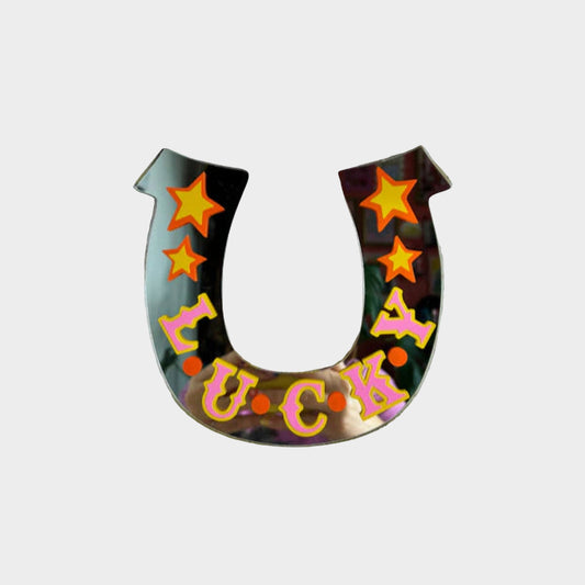 Horseshoe-shaped lucky charm with colorful letters on a textured white background
