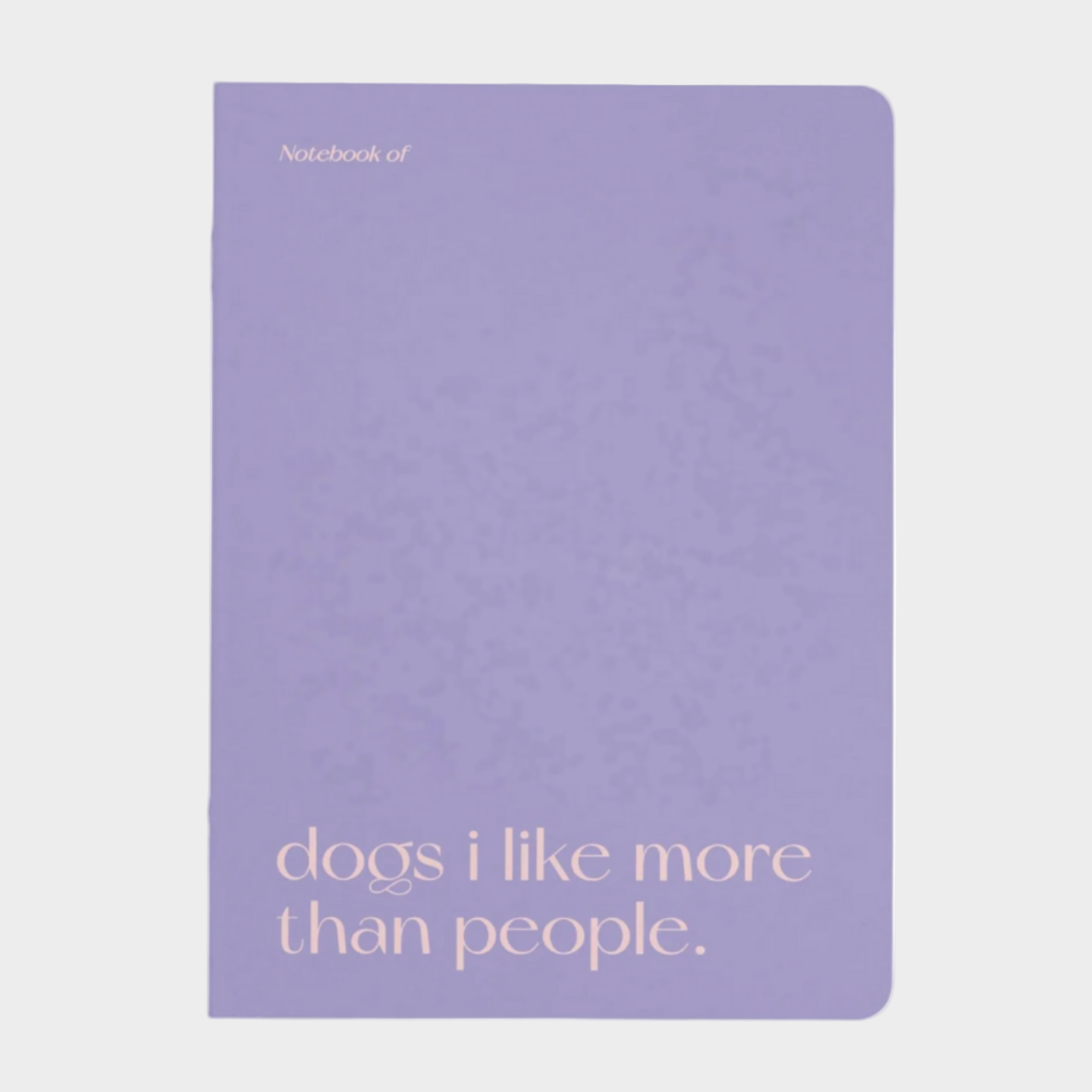 Purple notebook with text 'dogs i like more than people.' on a light gray background