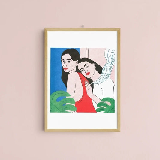 Framed artwork of two women embracing with a minimalist background
