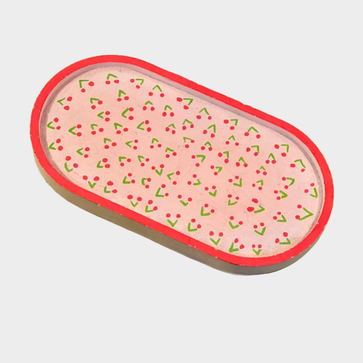 Rectangular eraser with pink design on a green background with text