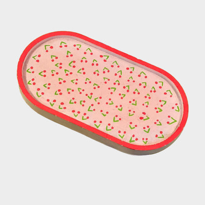 Rectangular eraser with pink design on a green background with text