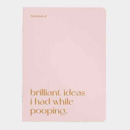 Pink notebook with gold text on a white background
