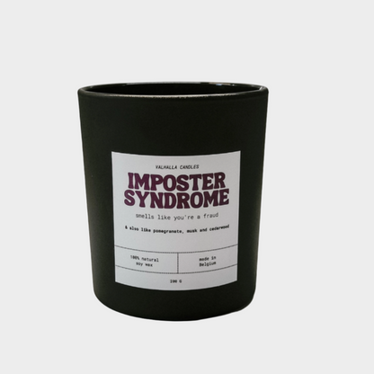 Black candle with a label titled 'Imposter Syndrome' on a white background