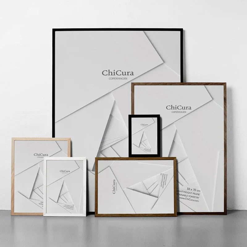 A collection of picture frames from the brand ChiCura, featuring a variety of sizes and a black frame in the background.