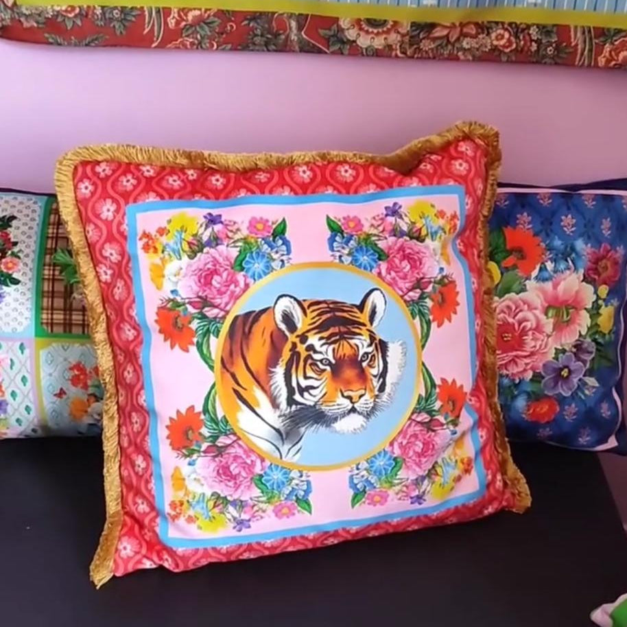Decorative pillow with a tiger design on a colorful background