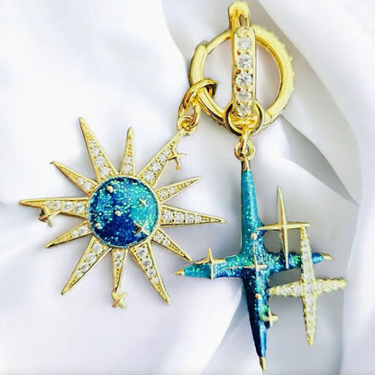 Gold and blue star-shaped earrings on a white background