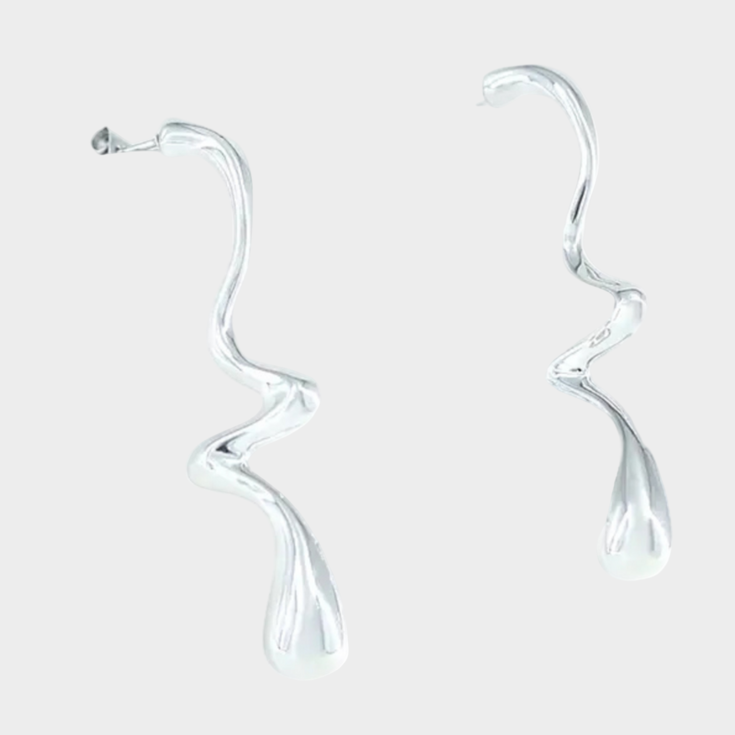 Silver earrings with a wavy design on a white background