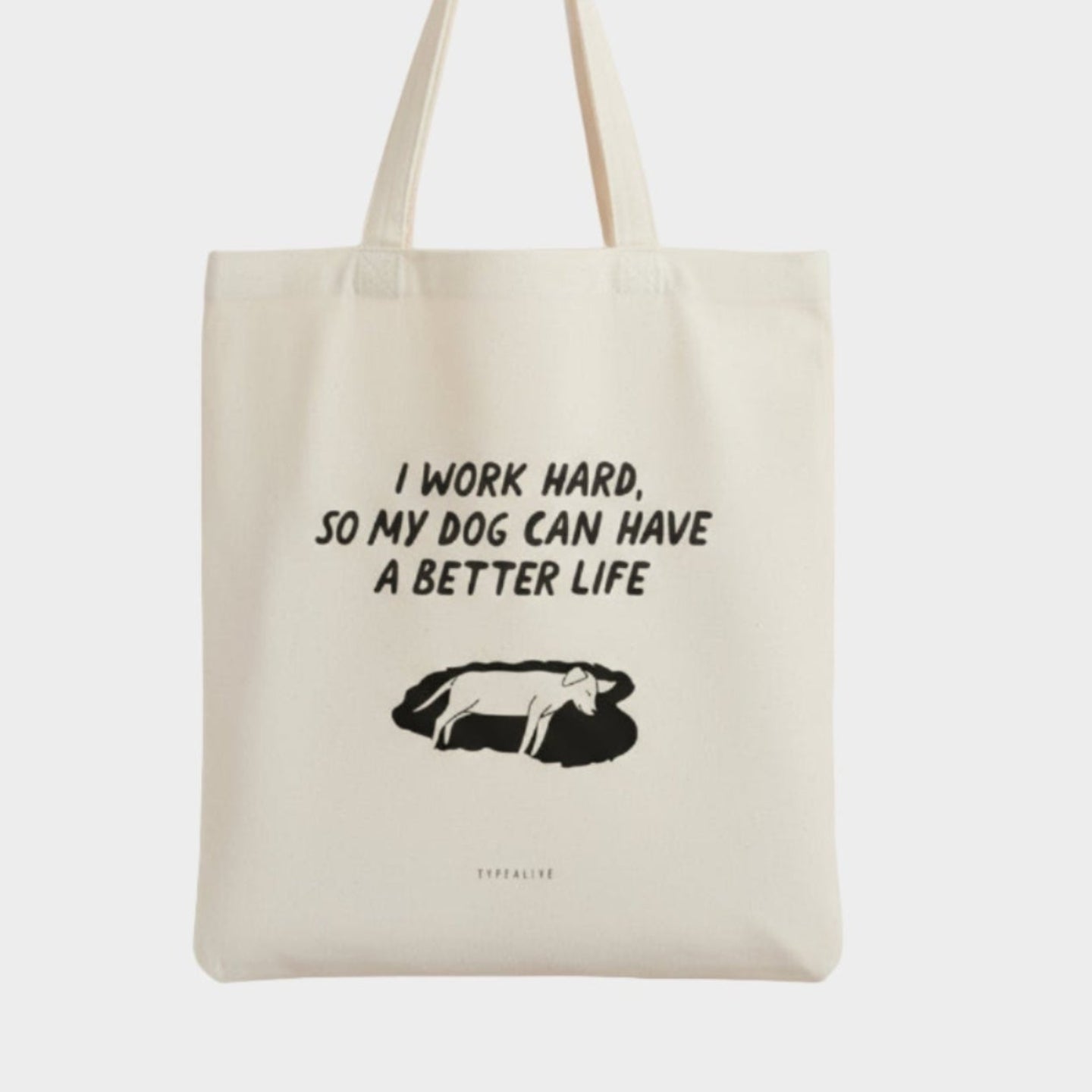 Tote bag with text 'I work hard, so my dog can have a better life' on a white background